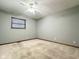 Cozy bedroom featuring plush carpeting, a simple ceiling fan, and a brightly lit window at 8616 Old Dominion Ct, Indianapolis, IN 46231