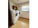 Well-lit laundry room equipped with machines and cabinets at 8616 Old Dominion Ct, Indianapolis, IN 46231