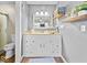A bright bathroom with a white vanity, a framed mirror, and a shower with a glass door at 919 Oak Park Dr, Shelbyville, IN 46176