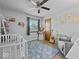 Bright bedroom with plush rug, ceiling fan, neutral paint, and cozy decor accents create an inviting space at 919 Oak Park Dr, Shelbyville, IN 46176