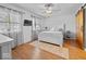 Bright bedroom featuring hardwood floors, a ceiling fan, a large window and a sliding barn door at 919 Oak Park Dr, Shelbyville, IN 46176