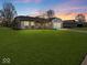 Attractive single-Gathering home with brick and siding exterior, a well-kept lawn, and mature trees, located in a quiet neighborhood at 919 Oak Park Dr, Shelbyville, IN 46176