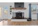 Charming fireplace with white brick surround, wooden mantle, and elegant hearth, creating a cozy focal point at 919 Oak Park Dr, Shelbyville, IN 46176