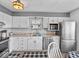A well-appointed kitchen with white cabinets, a stainless refrigerator, and matching appliances at 919 Oak Park Dr, Shelbyville, IN 46176