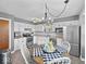 Bright eat-in kitchen with white cabinetry, stainless steel appliances and chandelier lighting at 919 Oak Park Dr, Shelbyville, IN 46176