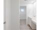 Bright bathroom with dual sinks, vanity, and view into the carpeted bedroom at 9222 Anthem Ave, Plainfield, IN 46168