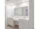 Modern bathroom features dual sinks, a large mirror, and sleek white cabinetry at 9222 Anthem Ave, Plainfield, IN 46168
