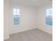 Bedroom with neutral walls, carpet, and two large windows for plenty of natural light at 9222 Anthem Ave, Plainfield, IN 46168