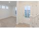 Bright entryway with a white front door, staircase, and view into a carpeted room at 9222 Anthem Ave, Plainfield, IN 46168