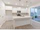 Modern kitchen boasts an island, stainless steel appliances, and plenty of cabinet space, perfect for cooking and entertaining at 9222 Anthem Ave, Plainfield, IN 46168