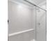 Updated walk-in shower features glass doors, tiled walls, and modern fixtures at 9222 Anthem Ave, Plainfield, IN 46168