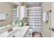 Bathroom featuring a neutral color scheme, white cabinets, and a shower with a striped curtain at 9328 Haddington W Dr, Indianapolis, IN 46256