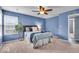 Bedroom featuring bright natural light, neutral carpet and blue walls with coordinated bedding at 9328 Haddington W Dr, Indianapolis, IN 46256