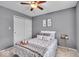 Comfortable bedroom with gray walls, neutral carpet, ceiling fan, and coordinated decor at 9328 Haddington W Dr, Indianapolis, IN 46256