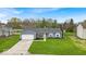 Beautifully landscaped single-story home with a two-car garage and a welcoming front porch at 9328 Haddington W Dr, Indianapolis, IN 46256