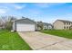 Lovely single-story home with an attached two-car garage and a spacious driveway at 9328 Haddington W Dr, Indianapolis, IN 46256