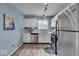 Well-lit kitchen with stainless steel appliances and white cabinets offering ample storage at 9328 Haddington W Dr, Indianapolis, IN 46256