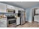 Efficient kitchen with stainless steel appliances, bright lighting and easy access to the laundry at 9328 Haddington W Dr, Indianapolis, IN 46256