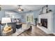 Inviting living room with fireplace, ceiling fan, and natural light from the patio doors at 9328 Haddington W Dr, Indianapolis, IN 46256