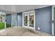 Enclosed sunroom featuring an exit door and blue siding in the backyard at 9328 Haddington W Dr, Indianapolis, IN 46256