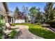 Landscaped backyard boasts lush greenery, a concrete patio, and a privacy fence, creating a serene outdoor oasis at 9435 Tamarack Dr # 94, Indianapolis, IN 46260