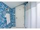 Stylish bathroom with blue scenic wallpaper, a white shower curtain and door, and a towel rack at 9435 Tamarack Dr # 94, Indianapolis, IN 46260