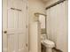 Bright white bathroom features a toilet, a shower with a white curtain, and a door with gold hooks at 9435 Tamarack Dr # 94, Indianapolis, IN 46260