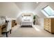 Spacious bedroom with vaulted ceilings, skylight, and carpet flooring with a bed and dressers at 9435 Tamarack Dr # 94, Indianapolis, IN 46260