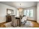 Charming dining room featuring a modern chandelier, large windows, and stylish decor at 9435 Tamarack Dr # 94, Indianapolis, IN 46260