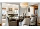 Elegant dining area with a dark wood table, neutral chairs, and views into the living room at 9435 Tamarack Dr # 94, Indianapolis, IN 46260
