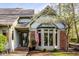 Close up of charming brick and siding home with prominent front door and American flag at 9435 Tamarack Dr # 94, Indianapolis, IN 46260