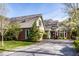 Charming home with brick accents, mature trees, and a spacious driveway under a clear blue sky at 9435 Tamarack Dr # 94, Indianapolis, IN 46260