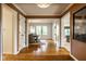Spacious hallway with hardwood floors that leads to the dining room and living areas at 9435 Tamarack Dr # 94, Indianapolis, IN 46260