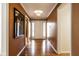 Welcoming hallway boasts gleaming hardwood floors, neutral tones, and ample natural light at 9435 Tamarack Dr # 94, Indianapolis, IN 46260
