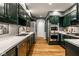 Modern kitchen featuring dark cabinets, stainless steel appliances, and hardwood floors at 9435 Tamarack Dr # 94, Indianapolis, IN 46260