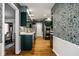 Stylish kitchen featuring patterned wallpaper, sleek countertops, and updated stainless steel appliances at 9435 Tamarack Dr # 94, Indianapolis, IN 46260