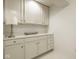Bright laundry room featuring white cabinets, laminate countertops, and modern lighting fixtures at 9435 Tamarack Dr # 94, Indianapolis, IN 46260