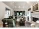 Elegant living room with fireplace, neutral tones, and seamless flow to an outdoor space at 9435 Tamarack Dr # 94, Indianapolis, IN 46260