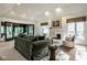 Bright living room featuring high ceilings, a fireplace, large windows, and an open floor plan at 9435 Tamarack Dr # 94, Indianapolis, IN 46260