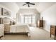 Bright main bedroom featuring vaulted ceiling, a ceiling fan, neutral decor and large windows for natural light at 9435 Tamarack Dr # 94, Indianapolis, IN 46260