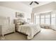 Bright main bedroom featuring vaulted ceiling, a ceiling fan, neutral decor and large windows for natural light at 9435 Tamarack Dr # 94, Indianapolis, IN 46260