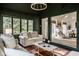 Inviting sunroom featuring vaulted ceilings, a seating area, and serene views of the surrounding greenery at 9435 Tamarack Dr # 94, Indianapolis, IN 46260
