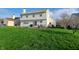 Exterior home shot showcases expansive lawn and outdoor patio set with seating, perfect for entertaining at 10629 Simsbury Ct, Indianapolis, IN 46236