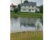 Picturesque backyard view of a house with a pond at 10629 Simsbury Ct, Indianapolis, IN 46236