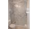 Modern bathroom featuring a glass-enclosed shower with elegant marble-style tiling at 10629 Simsbury Ct, Indianapolis, IN 46236