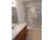 Bathroom with shower stall, marble walls, vanity and white toilet at 10629 Simsbury Ct, Indianapolis, IN 46236