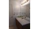 Bathroom with vanity, mirror, light fixture and blue walls at 10629 Simsbury Ct, Indianapolis, IN 46236