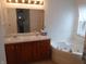 Bathroom featuring double vanity, whirlpool tub and tiled wall surround at 10629 Simsbury Ct, Indianapolis, IN 46236