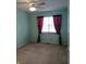 Cozy bedroom with ceiling fan, neutral carpet, and window with beautiful curtains at 10629 Simsbury Ct, Indianapolis, IN 46236