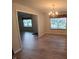 Bright dining room featuring two windows, a chandelier, and hardwood floors creating an inviting atmosphere at 10629 Simsbury Ct, Indianapolis, IN 46236